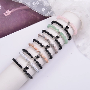 Detail view of colorful natural stone beads with heart magnet clasps for couple bracelets