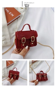 Detail view of wine red mini jelly bag with glossy PVC finish and gold chain strap