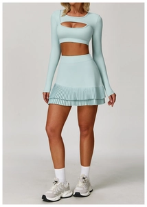 Detail of mint green yoga set with cutout long sleeve top and pleated sports skirt