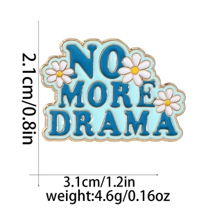 Detailed view of blue 'No More Drama' metal brooch with daisy and size measurements