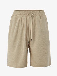 Close-up of khaki waffle texture fabric and adjustable drawstring on casual shorts