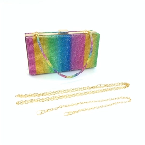 Detailed view of rectangular clutch bag with rainbow rhinestones and gold metal chains