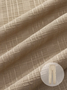 Macro shot of breathable waffle texture fabric on beige drawstring casual trousers