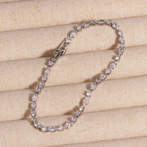 Close-up of marquise and round cut crystals on a silver chain with secure jewelry clasp
