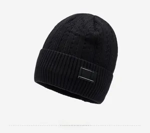 Detail of black knit beanie featuring wide ribbed cuff and rectangular IFARDI logo patch