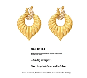 Detail of gold titanium steel heart earrings with rhinestones and radial pattern