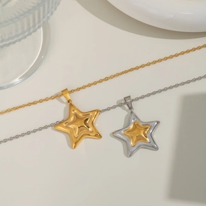 Chic two-tone and gold pentagram star necklaces displayed on a minimalist elegant background