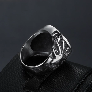 Macro detail of vintage octopus tentacle relief on a heavy stainless steel ship ring