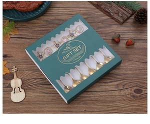 Close-up of gold stainless steel star pendant spoons in a premium gift box packaging