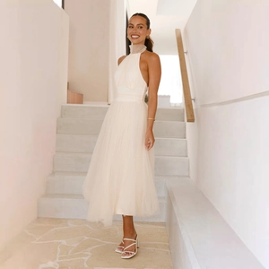 Detail of elegant white mesh fabric layers on a high-neck halter dress for women