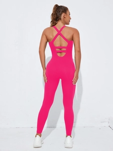 Detailed back view of hot pink seamless yoga jumpsuit with crisscross straps and cut-out