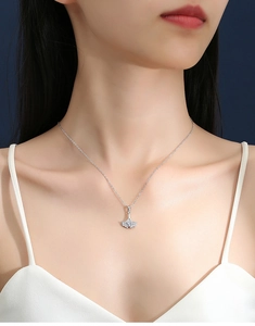 Detailed close-up of a silver ginkgo leaf pendant necklace featuring sparkling pavé stones