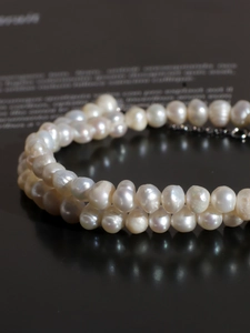 Macro detail showing smooth natural freshwater pearls with an elegant milky white luster