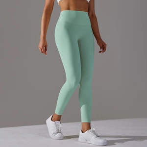 Close-up of high-waist seamless mint green yoga pants showing fabric texture and stretch fit
