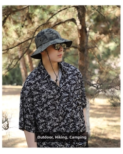 Outdoor camouflage sun hat with adjustable wind cord shown in forest setting