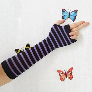 Y2K style striped knitted arm warmers in purple and black with vibrant butterfly accents