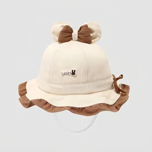 Off-white cotton baby bucket hat with cartoon ears and Lucky rabbit patch