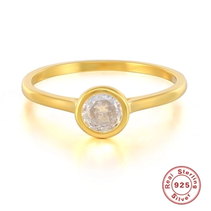Close-up of gold 925 sterling silver engagement ring with sparkling clear gemstone