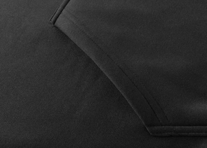 Close-up of premium black knitted fabric texture and seamless pocket stitching on hoodie