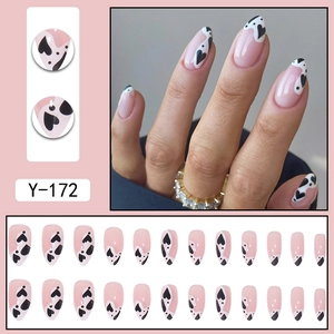 Pink almond press on nails with black heart patterns and full 24-piece set display