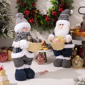 Detail of knitted Santa and Snowman dolls holding woven baskets in a festive scene