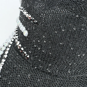 Macro view of grey mesh fabric with sparkling sequins and pearl embellishments on baseball cap