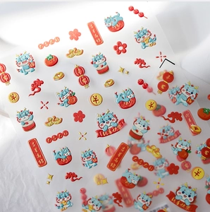 Macro shot of 3D embossed Lunar New Year nail stickers with cute dragon and lantern motifs