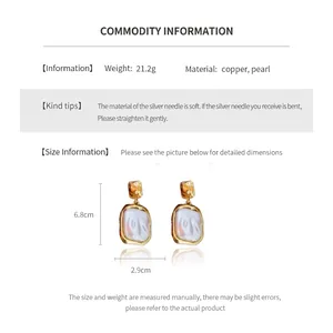 Detailed view of Baroque pearl earrings with golden copper base and size dimensions