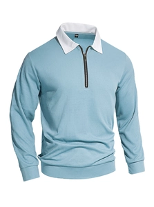 Detail of waffle knit fabric texture and contrast collar on light blue men's zip polo shirt