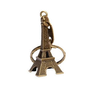 Vintage bronze Eiffel Tower keychain with Paris engraving and France tag on white background