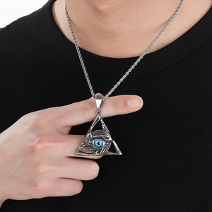 Detail of Viking Eye of Providence pendant with turquoise resin inlay on twisted chain