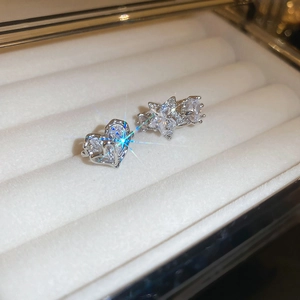 Elegant silver zircon heart and star clip earrings displayed on velvet box
