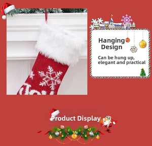 Close-up of red knitted Christmas stocking with plush cuff and snowflake embroidery