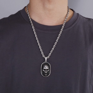 Punk style silver skull pendant necklace with twist chain on male model for street fashion