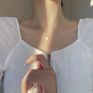 925 sterling silver heart shell necklace on model with elegant sunlight effect
