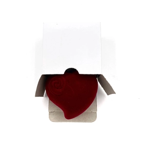 Red heart-shaped flocked jewelry box shown with its clean white paper outer packaging
