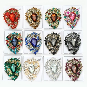 Matrix display of twelve colorful heart-shaped crystal brooches with rhinestone accents