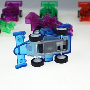 Detail view of colorful transparent F1 toy cars showing chassis and metal axles