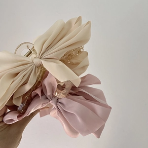 Elegant satin bow hair claw clips in beige and pink for princess style updos