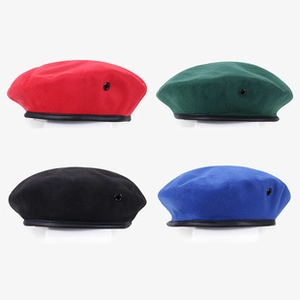 Close-up of sequin beret hats in red, dark green, black and royal blue with leather trim