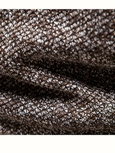 Macro texture of thick coffee brown knit fabric showing the soft fiber weave and thickness