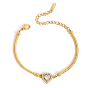 Macro detail of 18K gold stainless steel bracelet with heart-shaped zircon pendant