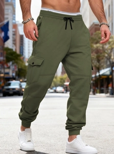 Army green cargo joggers with multiple pockets and drawstring waist in urban street setting