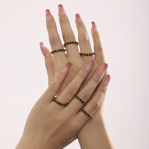 Set di 6 anelli placcati in oro con pietre nere sulla mano per un look minimalista