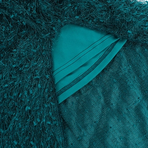Detail of dark green dress showing fringed faux fur texture with mesh lining