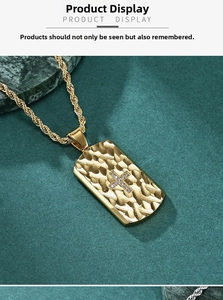 Detail of gold rectangular pendant with woven texture and crystal cross on twisted rope chain