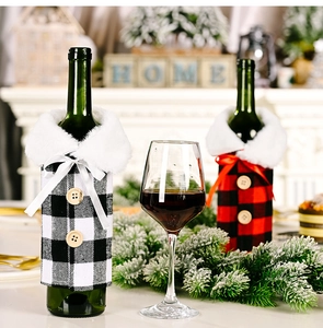 Close-up of red and black buffalo plaid wine bottle covers with white faux fur collars
