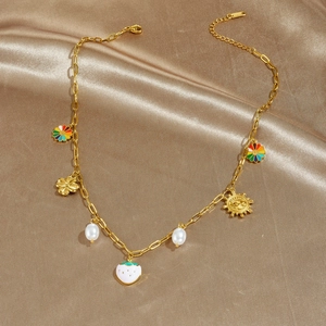 Colorful pendant necklace with pearl strawberry and sunflower charms on gold silk cloth