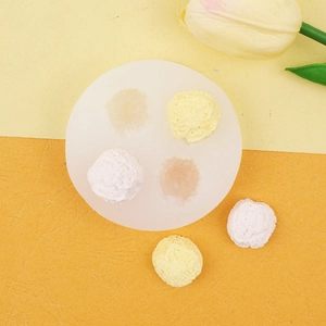 Macro detail of a 4-cavity silicone mold with finished round ice cream ball desserts