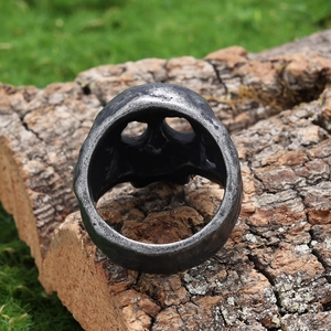 Vintage skull ring in distressed silver steel on rustic wood background for men